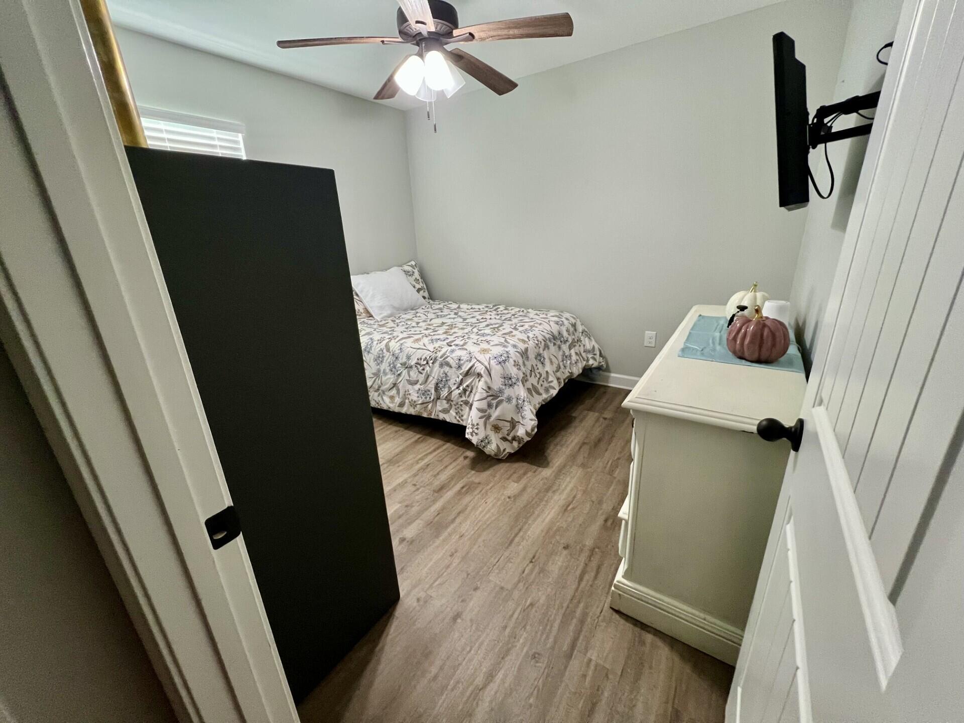 4948 Guernsey Road Pace, FL 32571 - Photo 13 of 25 a bedroom with a bed and a dresser