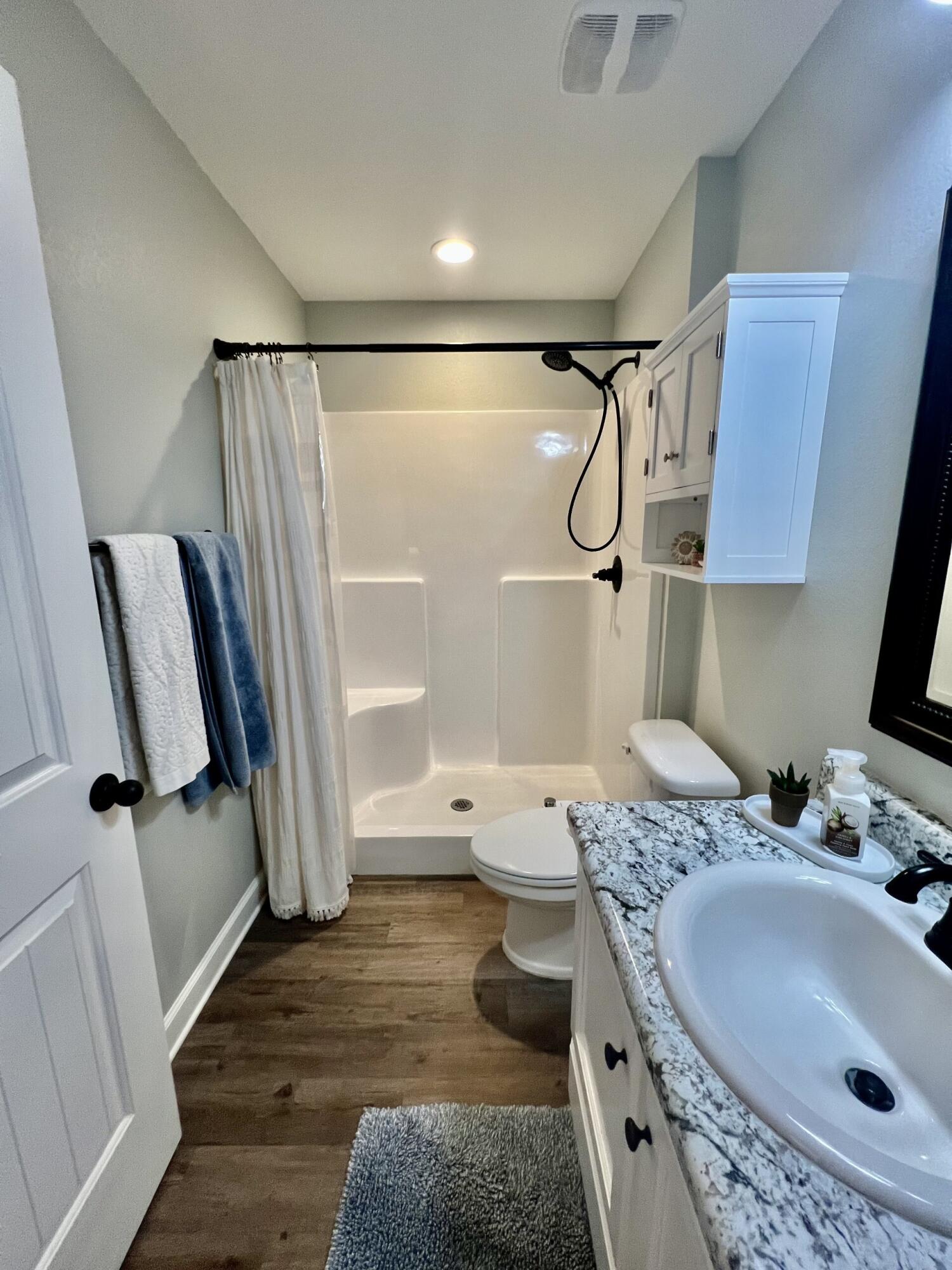 4948 Guernsey Road Pace, FL 32571 - Photo 15 of 25 a bathroom with a sink toilet and shower