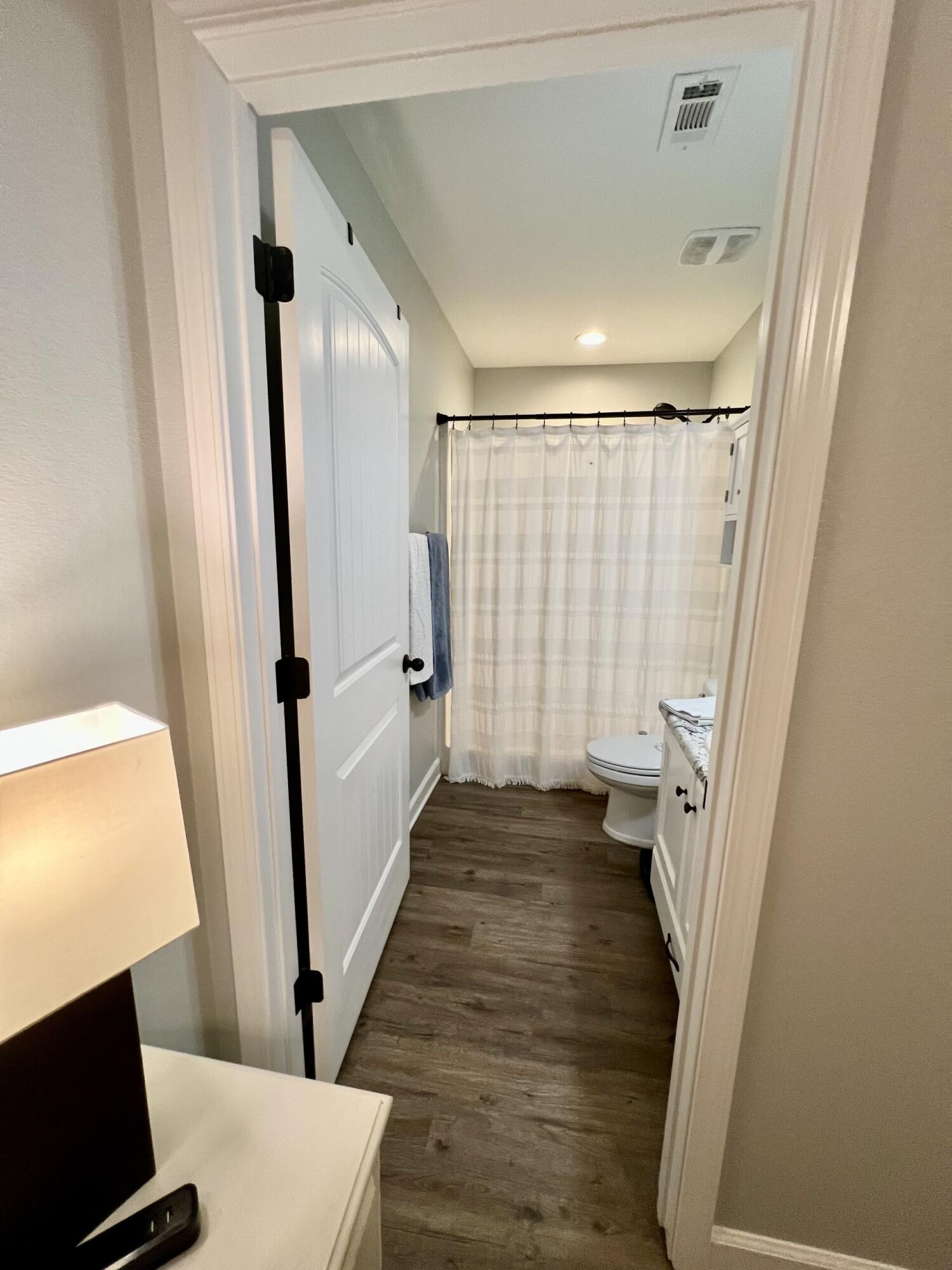 4948 Guernsey Road Pace, FL 32571 - Photo 16 of 25 a view of a room with wooden floor and chair