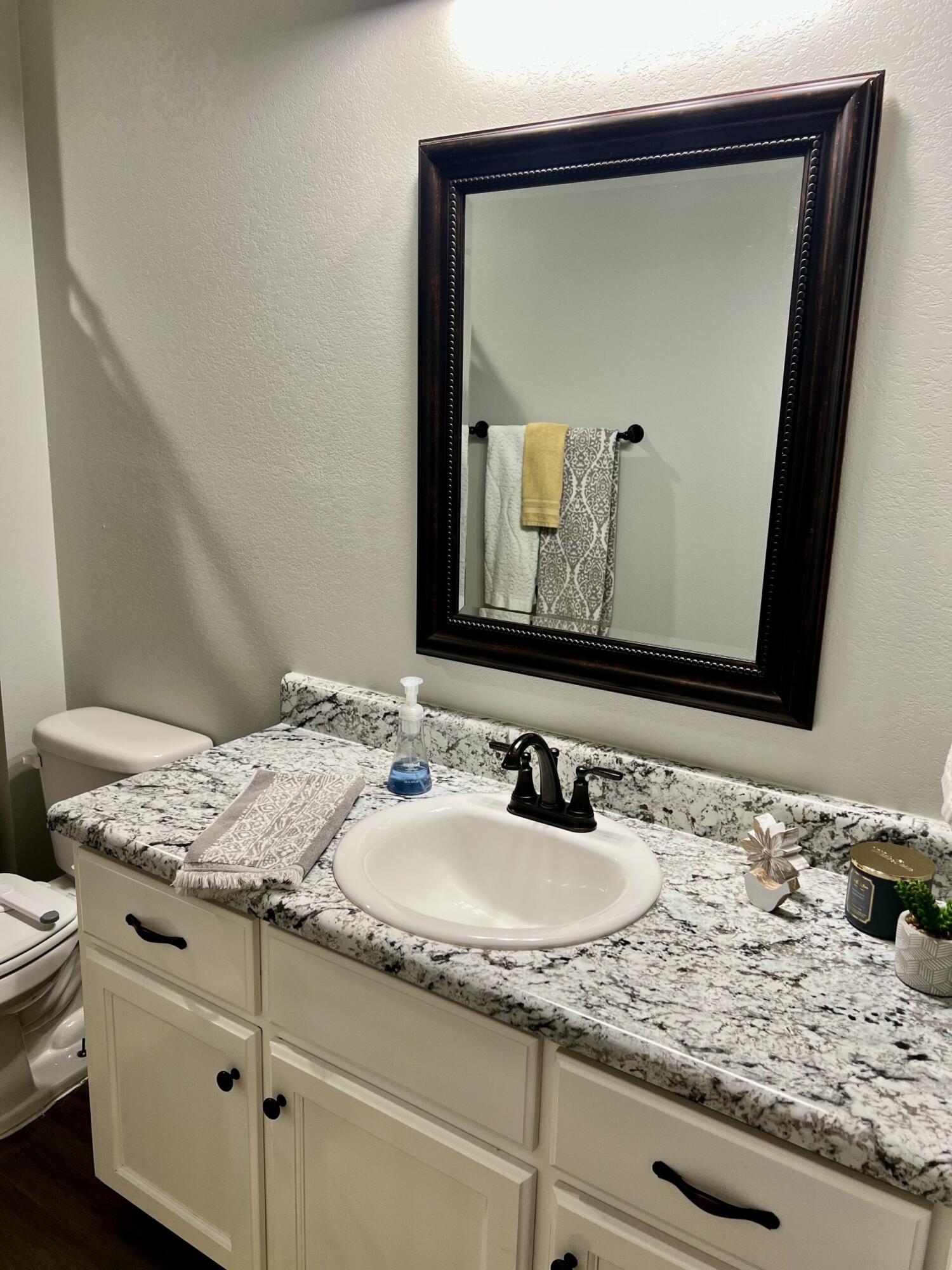 4948 Guernsey Road Pace, FL 32571 - Photo 17 of 25 a bathroom with a granite countertop sink and a mirror