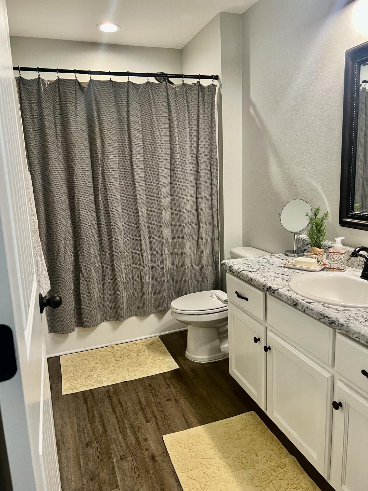 4948 Guernsey Road Pace, FL 32571 - Photo 20 of 25 a bathroom with a granite countertop sink and a mirror
