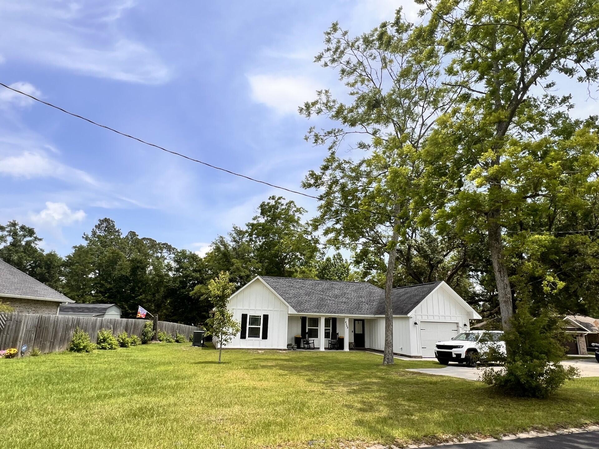 4948 Guernsey Road Pace, FL 32571 - Photo 2 of 25 a house with swimming pool in front of it