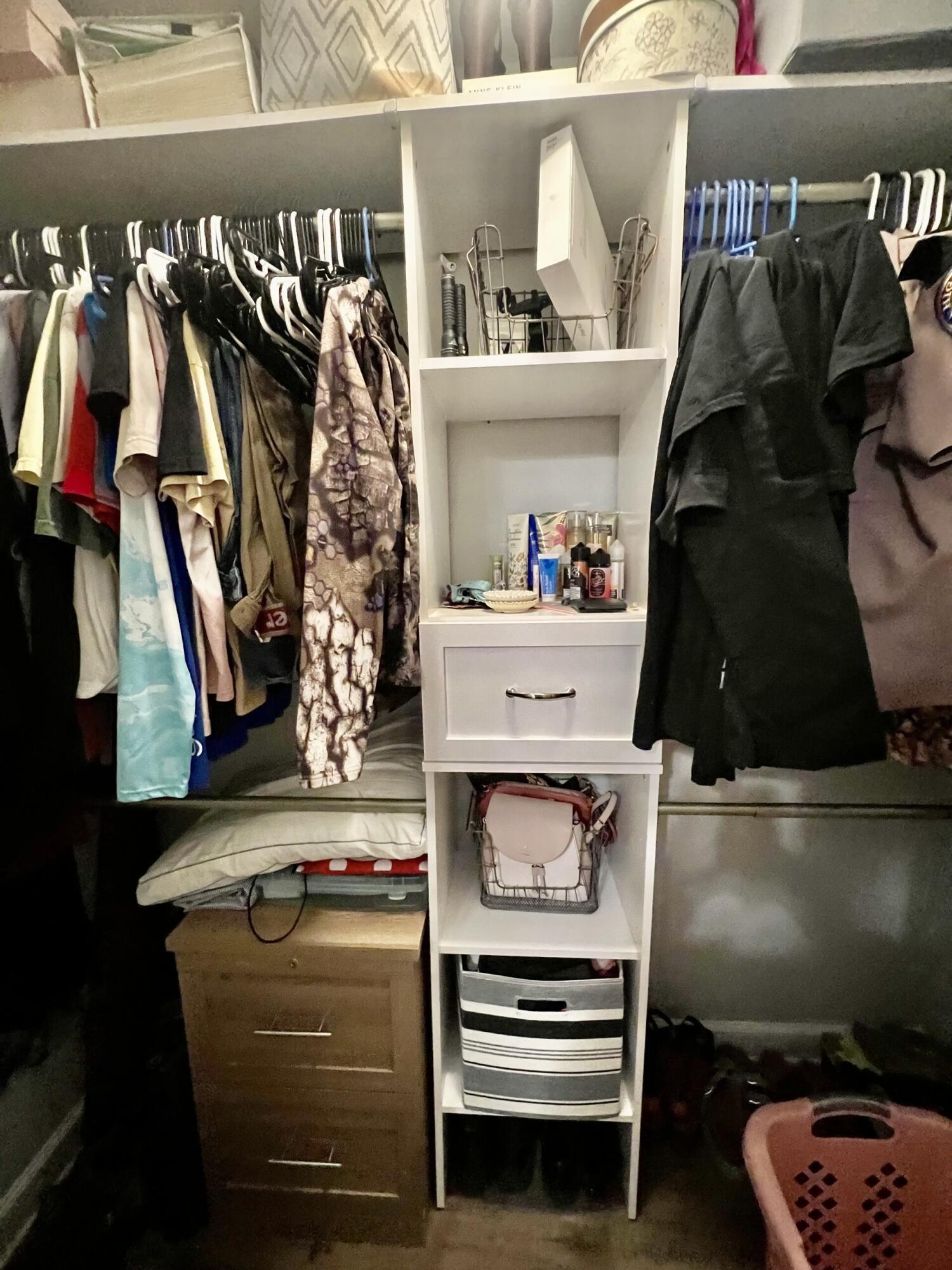 4948 Guernsey Road Pace, FL 32571 - Photo 22 of 25 a view of walk in closet with clothes and shoes