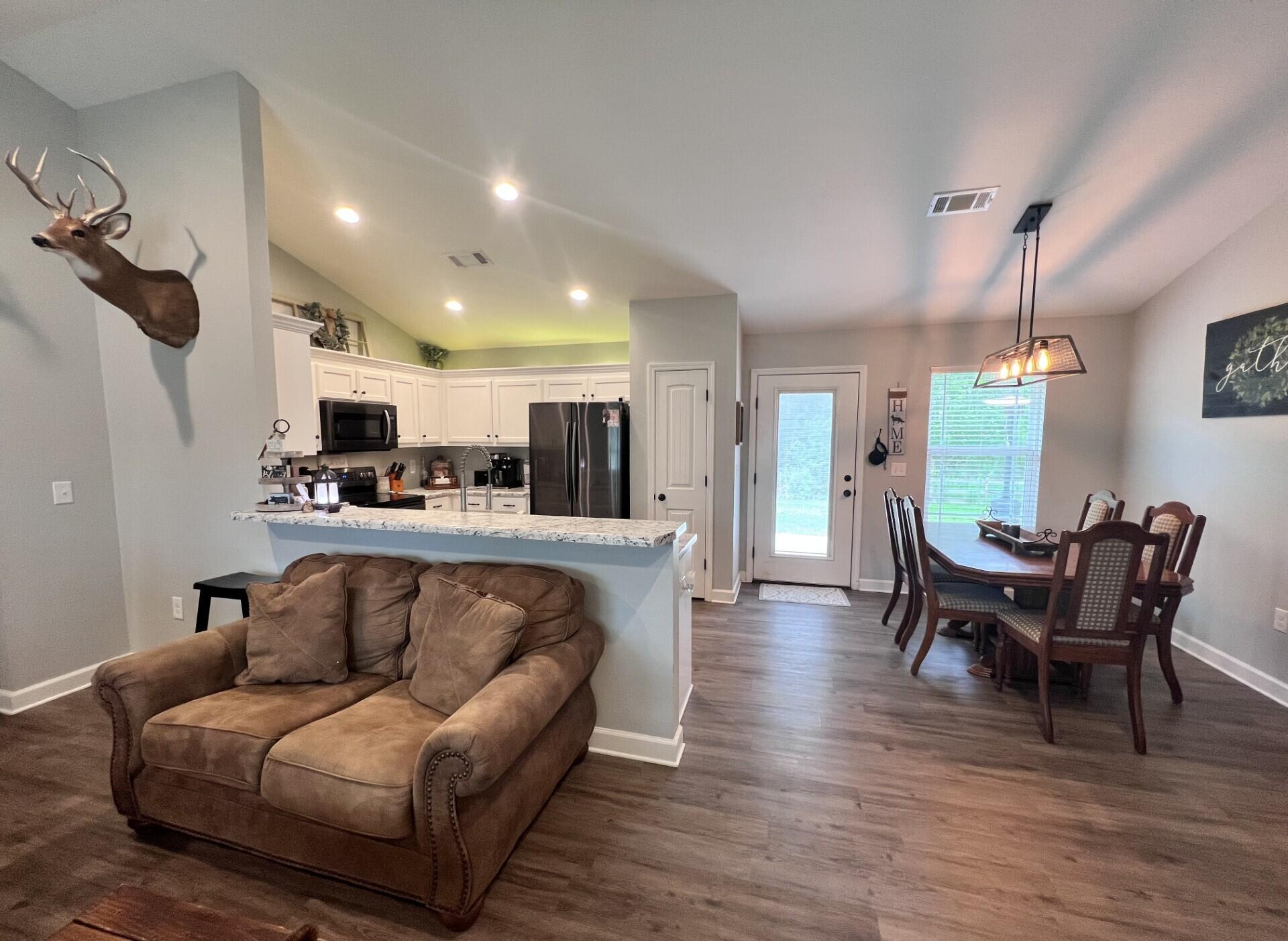 4948 Guernsey Road Pace, FL 32571 - Photo 5 of 25 a living room with furniture and a wooden floor