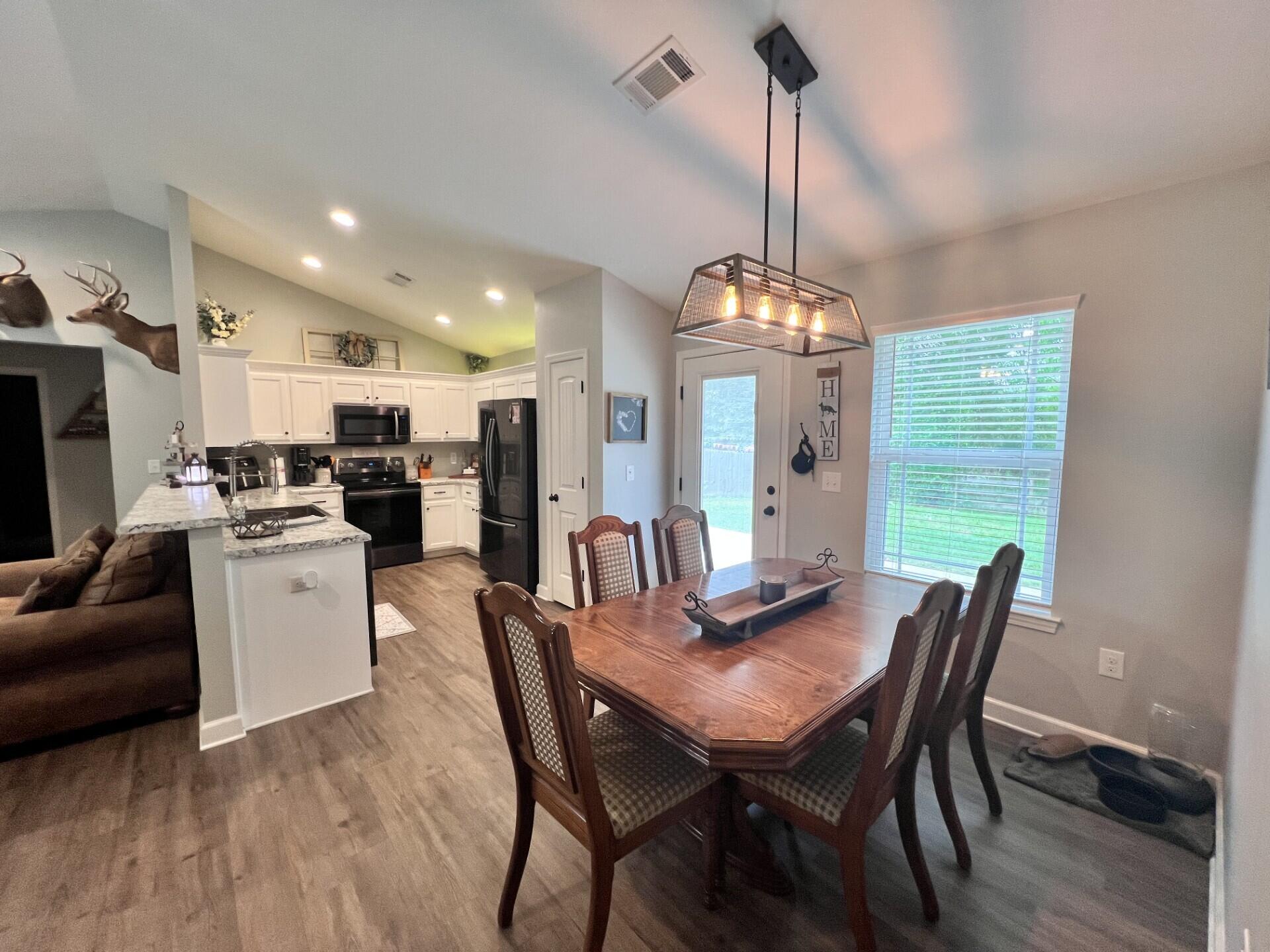 4948 Guernsey Road Pace, FL 32571 - Photo 6 of 25 a view of a dining room with furniture window and wooden floor