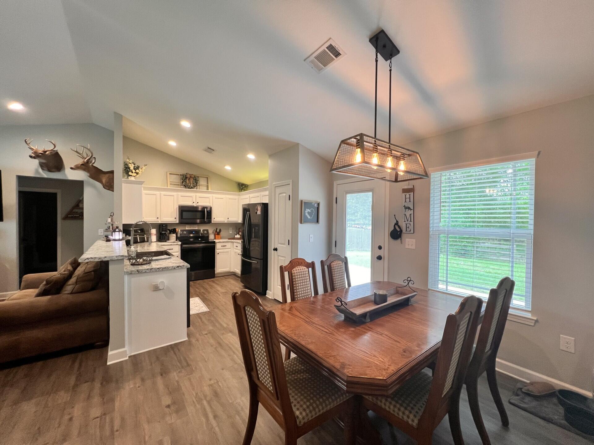 4948 Guernsey Road Pace, FL 32571 - Photo 7 of 25 a view of a dining room with furniture window and outside view