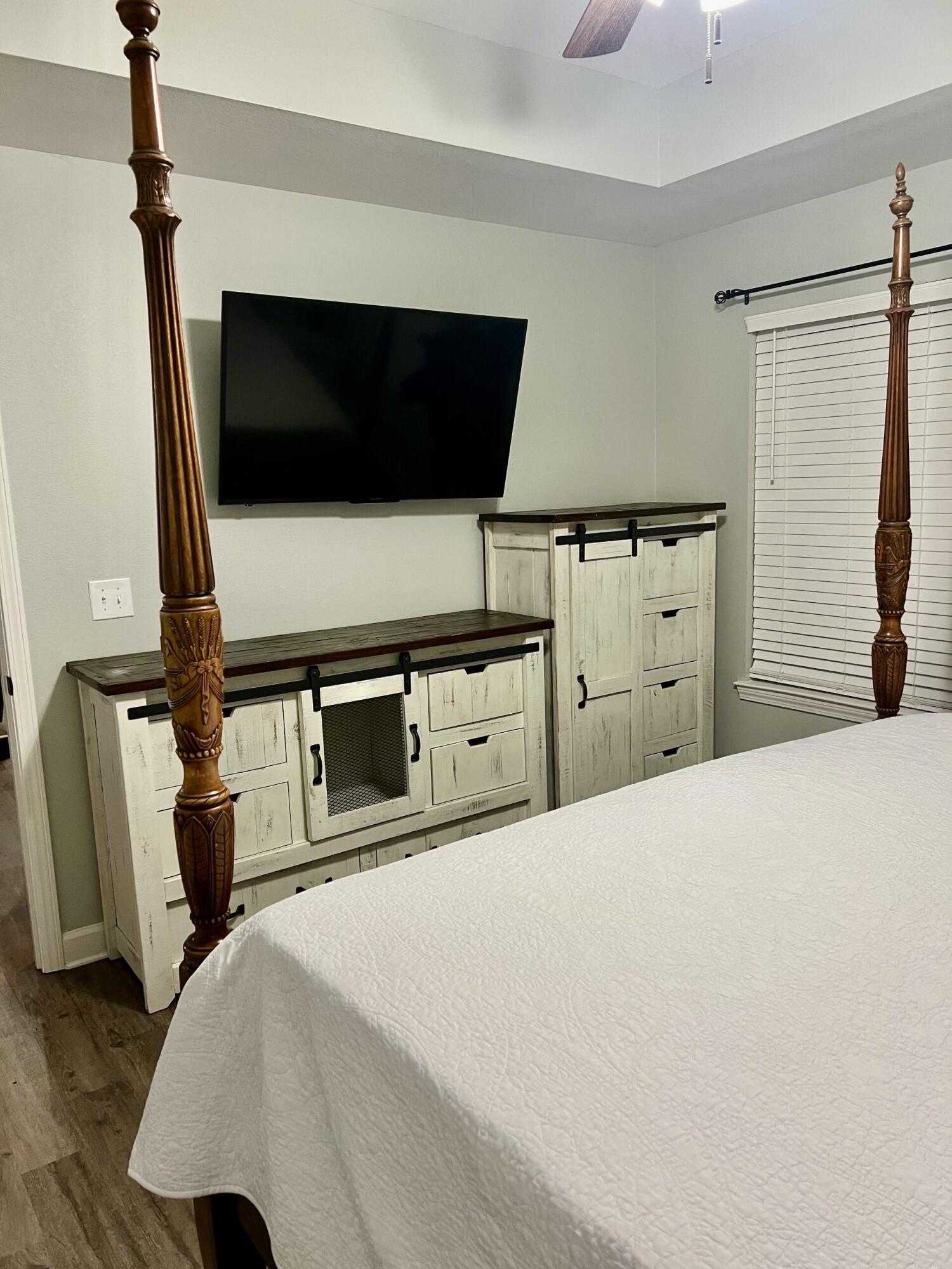 4948 Guernsey Road Pace, FL 32571 - Photo 10 of 25 a bedroom with a bed and a flat screen tv