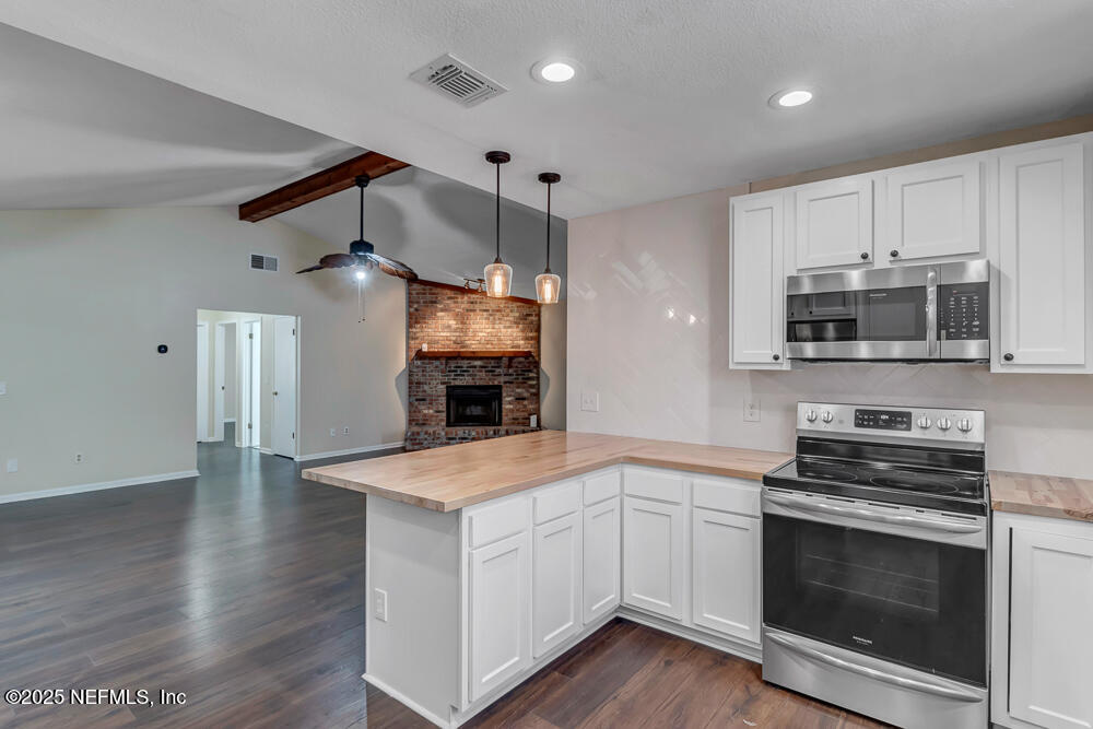 4518 Crosstie Road South Jacksonville, FL 32257 - Photo 13 of 28 a kitchen with granite countertop a stove and a microwave