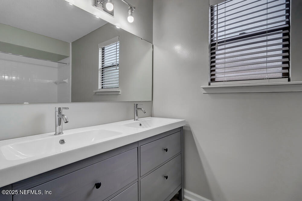 4518 Crosstie Road South Jacksonville, FL 32257 - Photo 18 of 28 a bathroom with a sink and a mirror