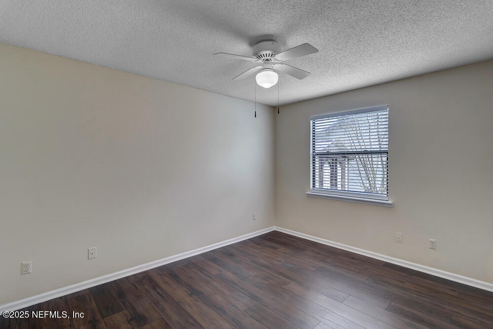 4518 Crosstie Road South Jacksonville, FL 32257 - Photo 20 of 28 an empty room with wooden floor and windows