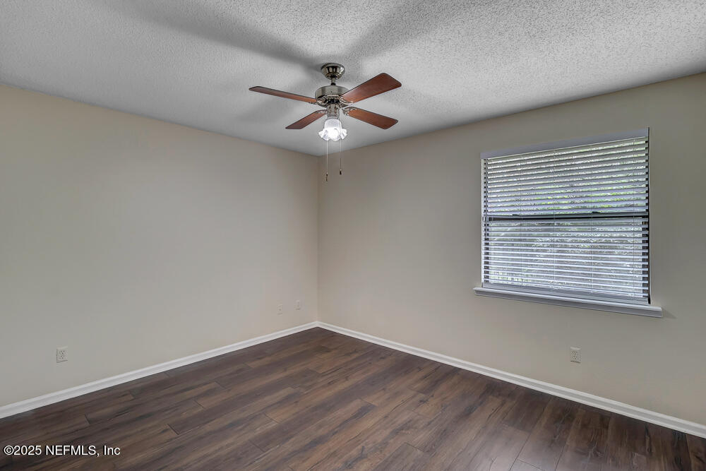 4518 Crosstie Road South Jacksonville, FL 32257 - Photo 24 of 28 a view of an empty room with wooden floor and a window