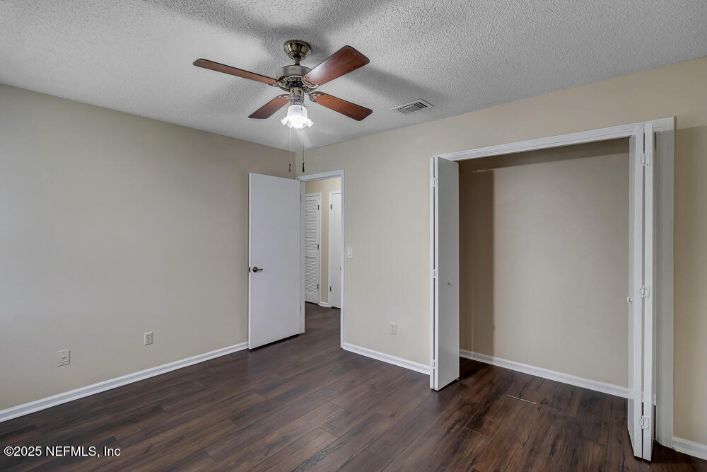 4518 Crosstie Road South Jacksonville, FL 32257 - Photo 25 of 28 a view of an empty room with wooden floor