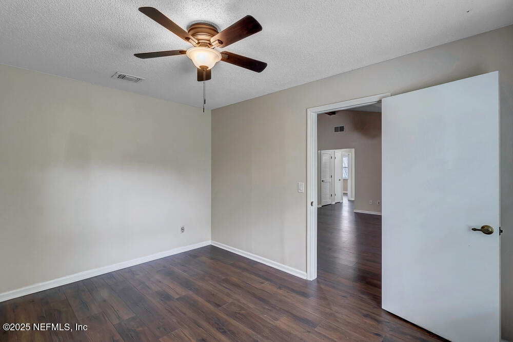 4518 Crosstie Road South Jacksonville, FL 32257 - Photo 26 of 28 a view of an empty room with wooden floor