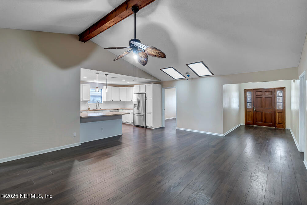 4518 Crosstie Road South Jacksonville, FL 32257 - Photo 6 of 28 a view of an empty room with window wooden floor and a kitchen