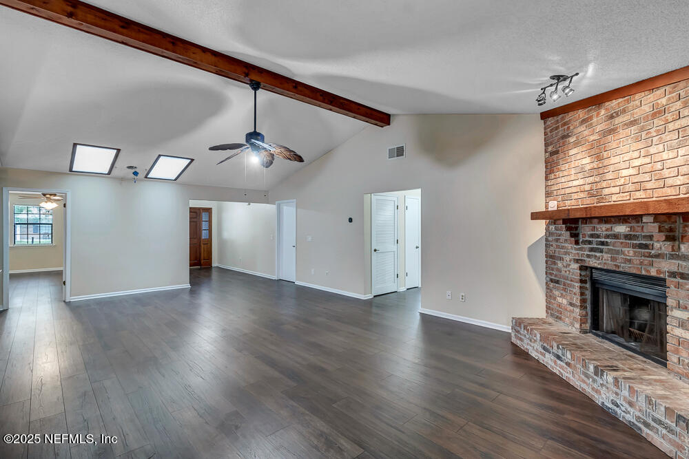 4518 Crosstie Road South Jacksonville, FL 32257 - Photo 10 of 28 a view of an empty room with wooden floor fireplace and a window