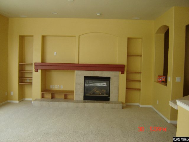 9661 Shadowstone Way Reno, NV 89521 - Photo 3 of 9 a room with a fireplace