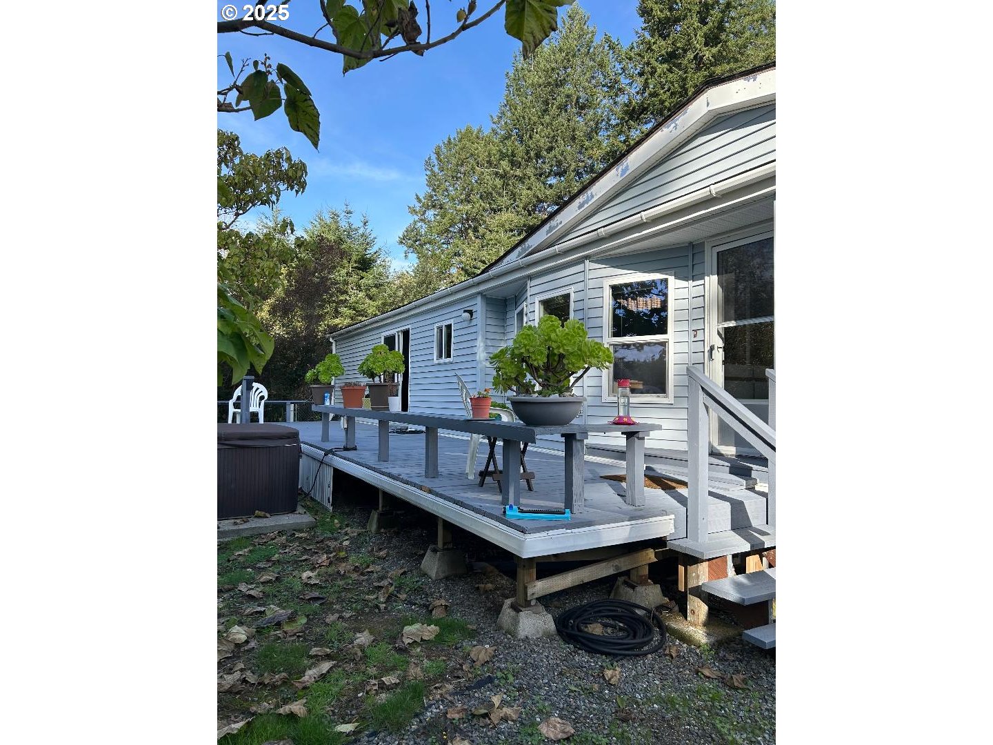 96465 Coverdell Road, Unit 20 Brookings, OR 97415 - Photo 20 of 21 a backyard of a house with table and chairs