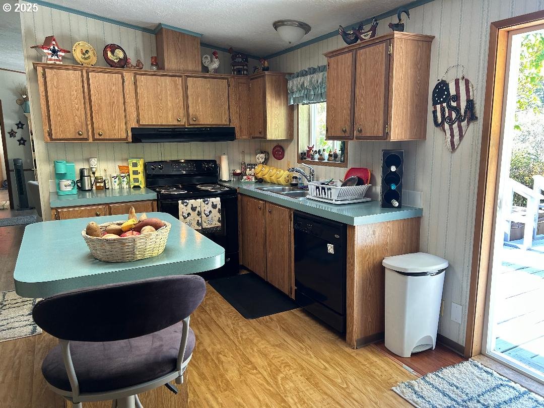 96465 Coverdell Road, Unit 20 Brookings, OR 97415 - Photo 7 of 21 a kitchen with a sink a stove and a refrigerator