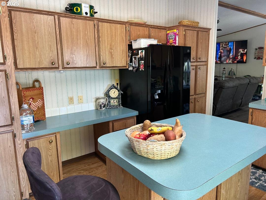 96465 Coverdell Road, Unit 20 Brookings, OR 97415 - Photo 8 of 21 a kitchen with stainless steel appliances kitchen island granite countertop a refrigerator a stove a sink and dishwasher