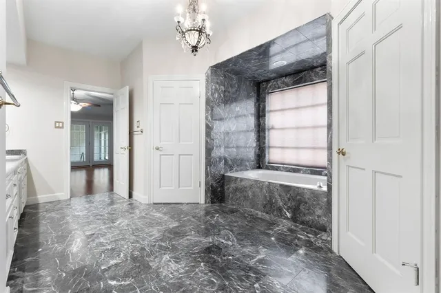 a view of a bathroom with a bathtub and shower