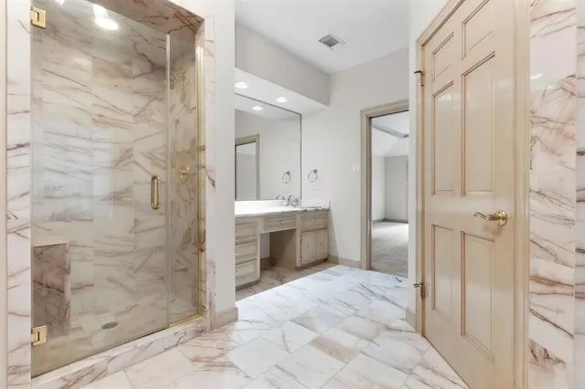 a bathroom with a shower and a mirror