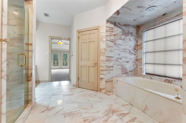 a bathroom with a bathtub and a shower