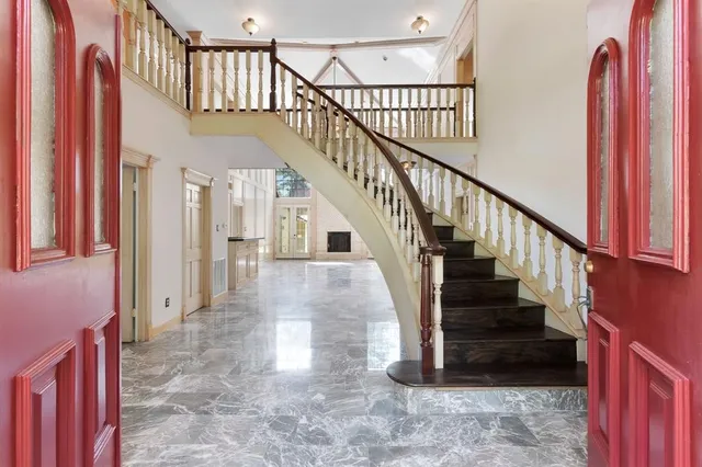 a view of entryway and hall with wooden floor