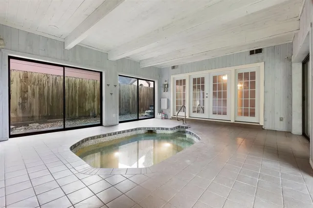 a view of a swimming pool and porch in the room
