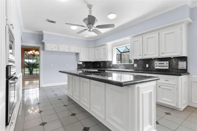 a kitchen with stainless steel appliances granite countertop a stove sink and cabinets