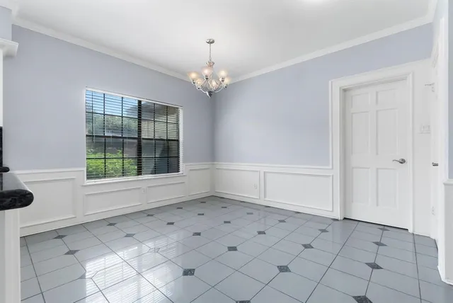 an empty room with windows and ceiling fan