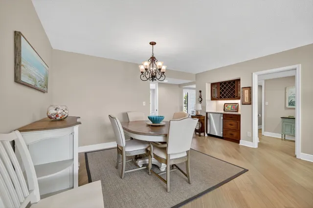 a dining room with furniture window and wooden floor