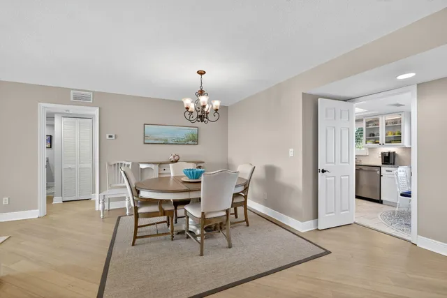 a dining room with furniture a rug and wooden floor