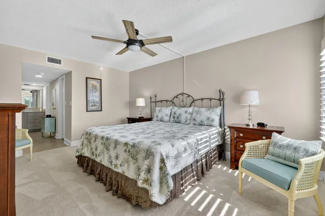 a bathroom with a granite countertop sink mirror vanity and toilet