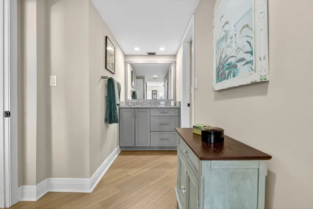 a view of a house with a big yard and potted plants and large trees