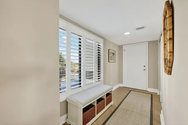 a view of a hallway with furniture and front door