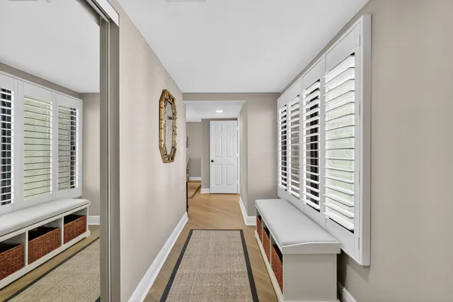 a dining room with furniture a chandelier and wooden floor