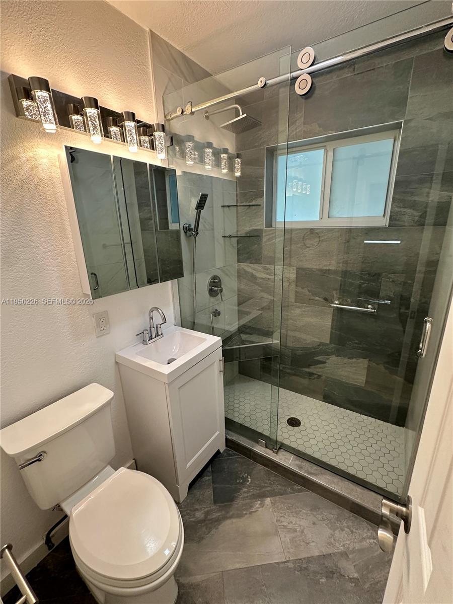 1811 Southwest 83rd Avenue Miami, FL 33155 - Photo 18 of 24 a white toilet sitting next to a bathroom sink