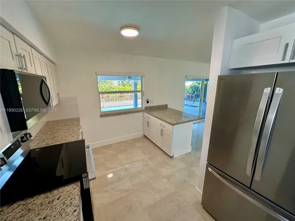 a kitchen with a refrigerator and a sink