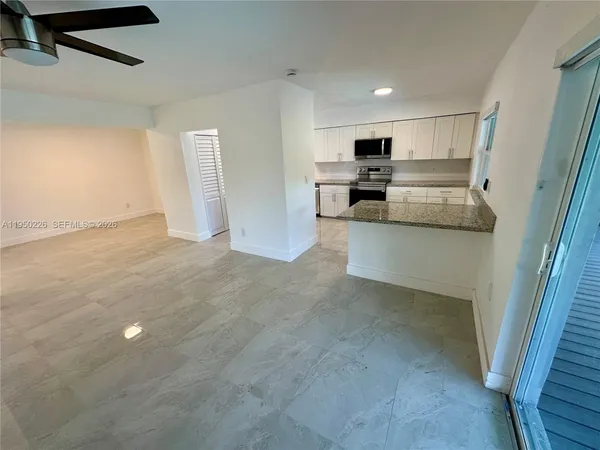a view of kitchen with stainless steel appliances refrigerator oven