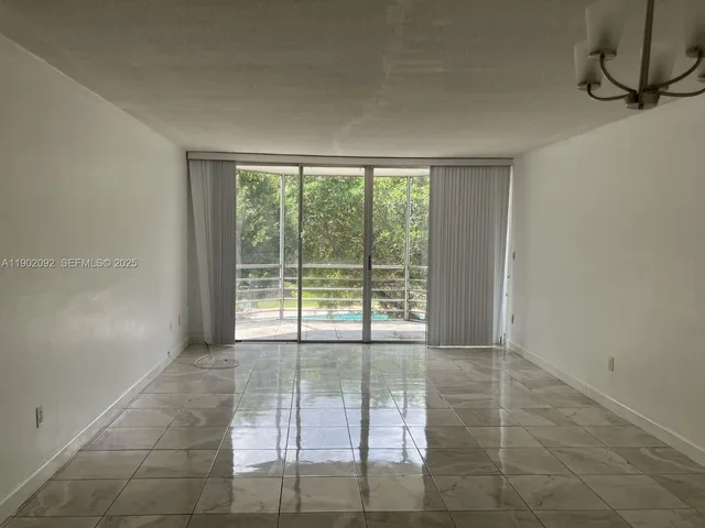 a view of an empty room with glass door