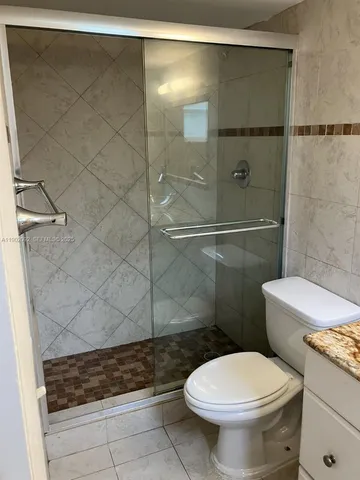 a bathroom with a toilet and a shower