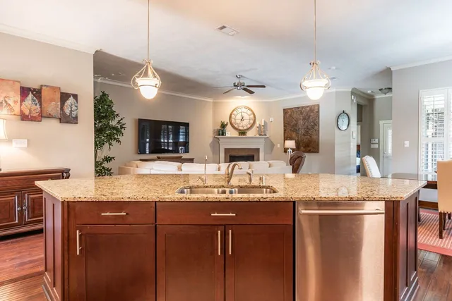 a bathroom with a granite countertop double vanity sink and a mirror
