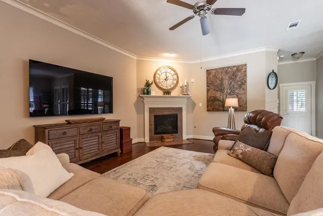 a living room with furniture a flat screen tv and a fireplace