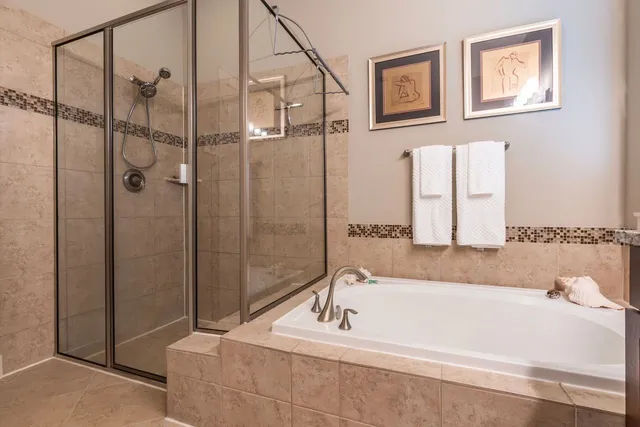 a bathroom with a tub and shower
