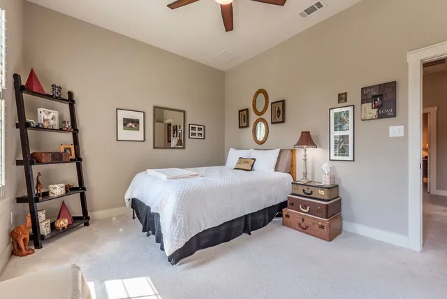 a bedroom with a bed and a large window