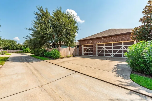a dining room with furniture a chandelier and wooden floor