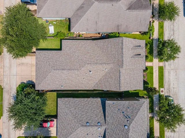 an aerial view of residential houses with outdoor space and lake view