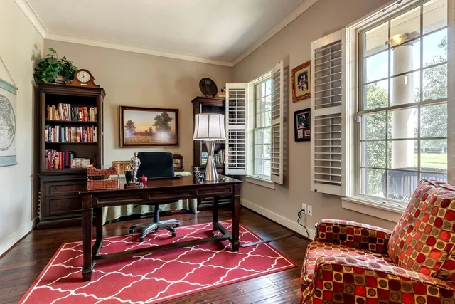 a living room with furniture and a bookshelf