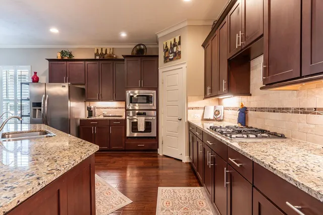 a kitchen with refrigerator and stove
