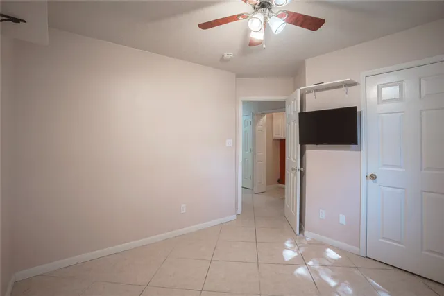 en empty room with an empty space and a ceiling fan